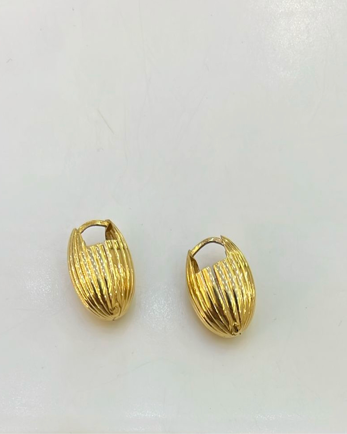 Yellow gold irregular hoops